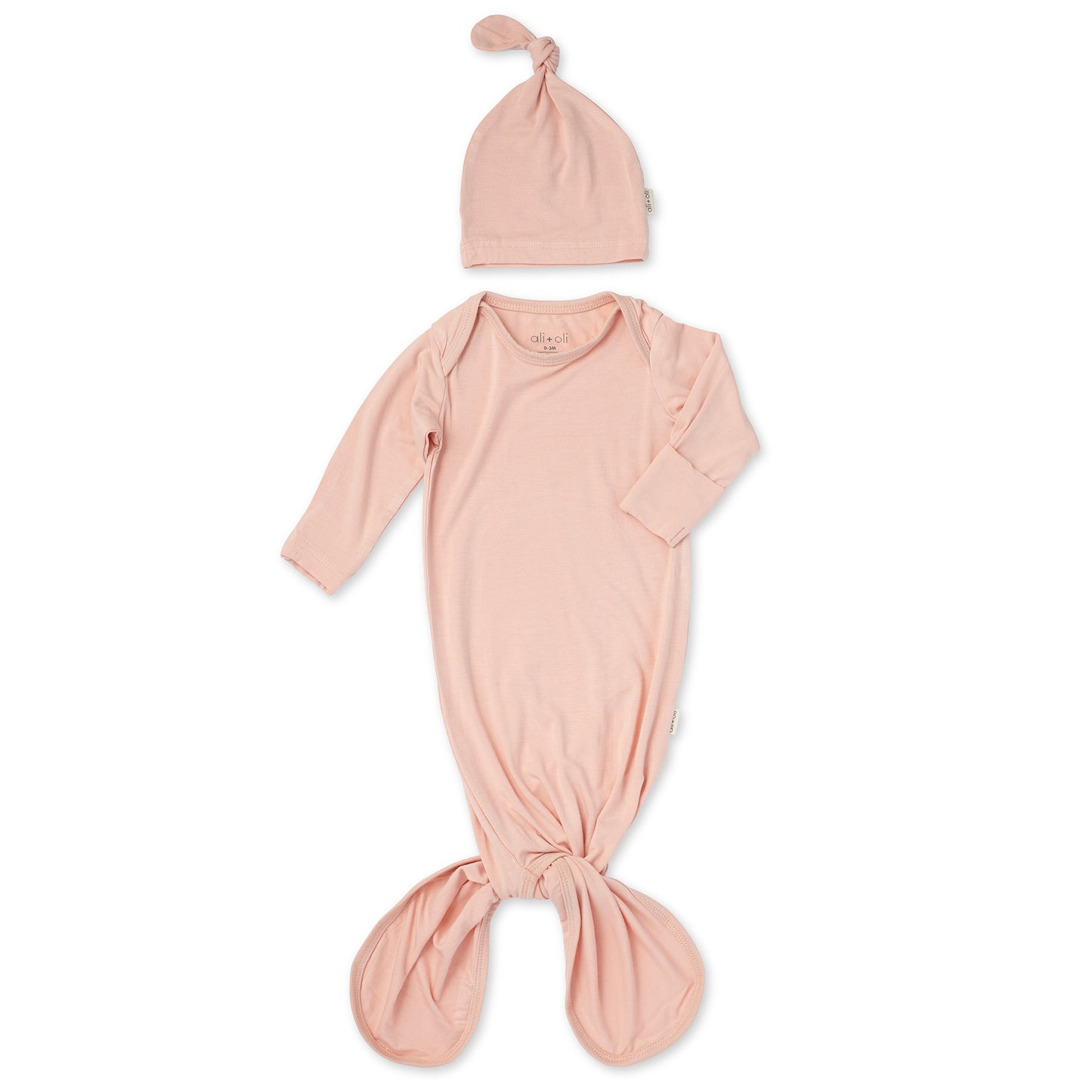 Pink baby wrap and hat set on a white background