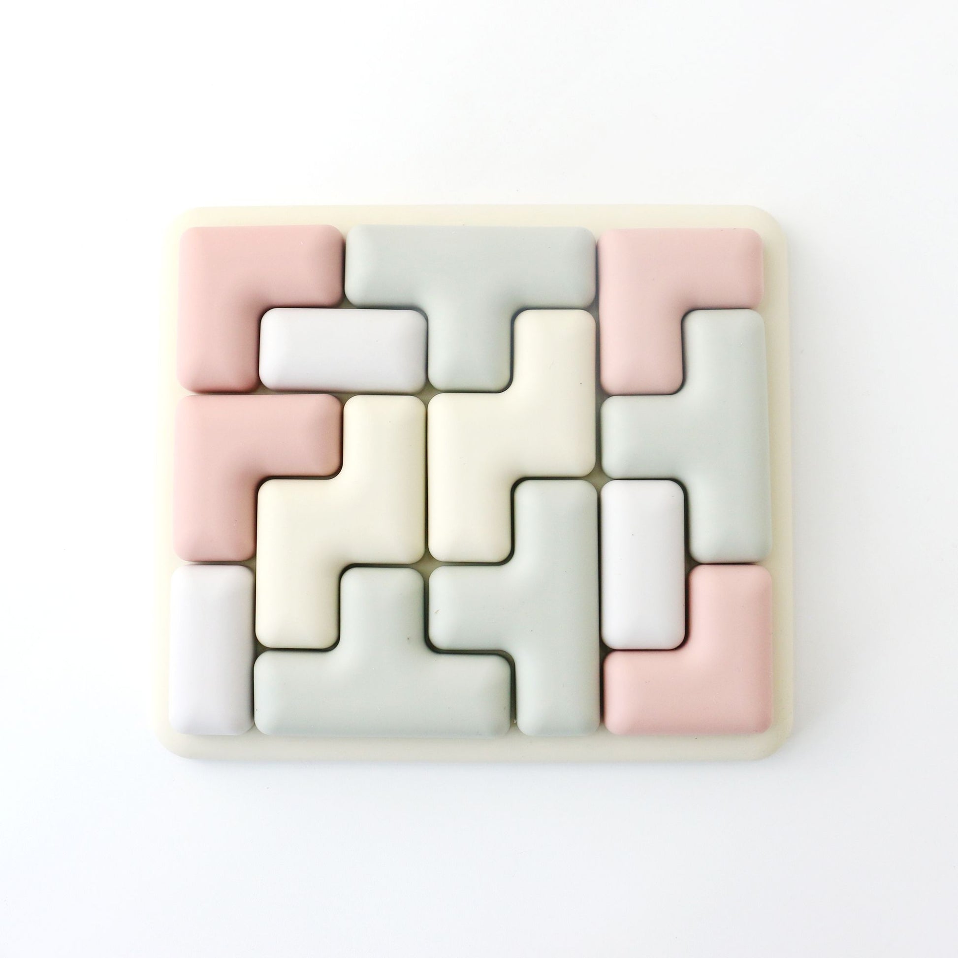 Geometric tile puzzle with pastel colors on a white background