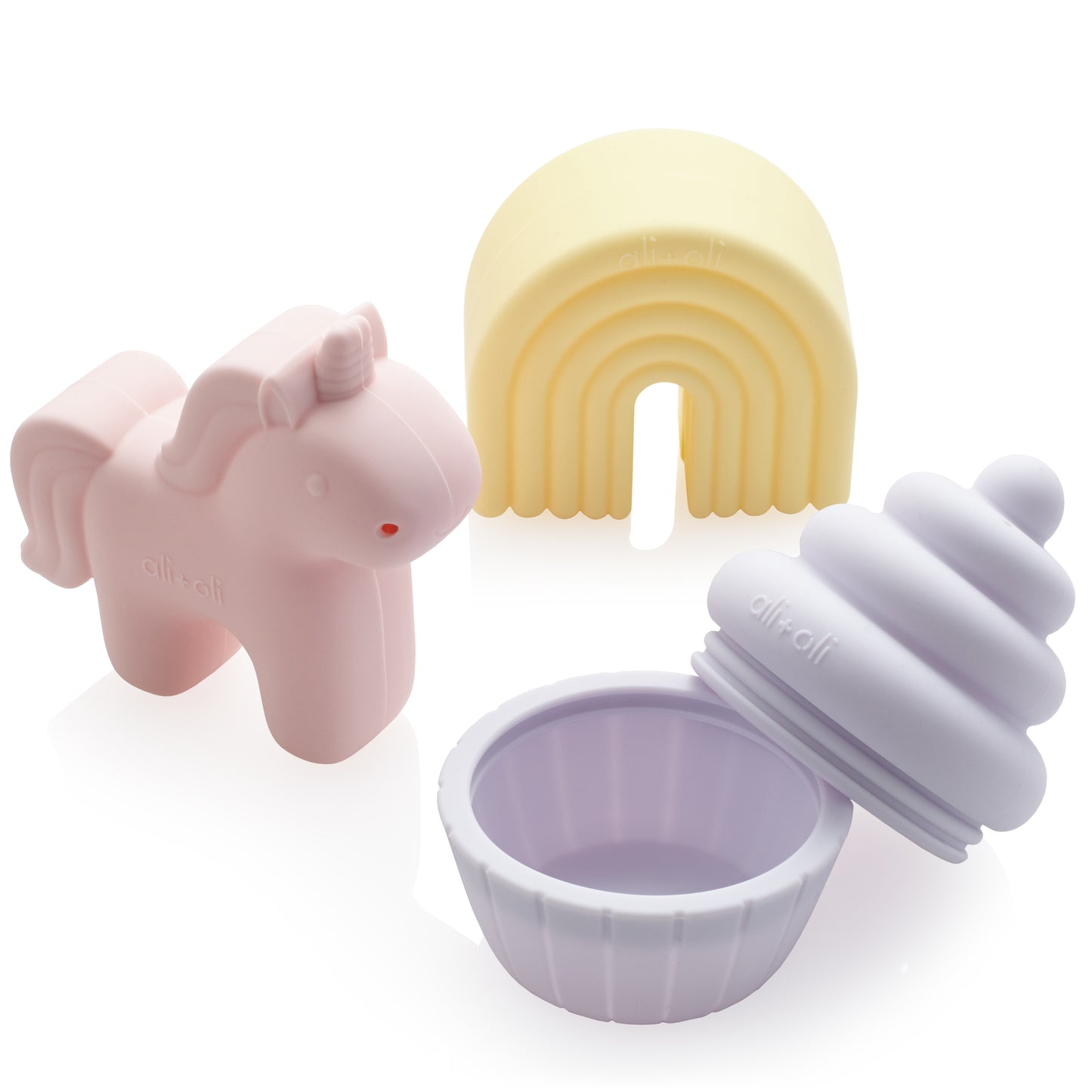 Silicone mold shaped like a unicorn, rainbow, and cupcake on a white background