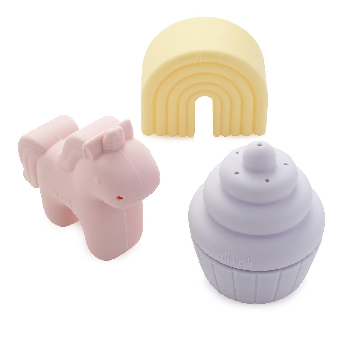 Pink unicorn-shaped object, yellow rainbow-shaped object, and purple cupcake-shaped object on a white background