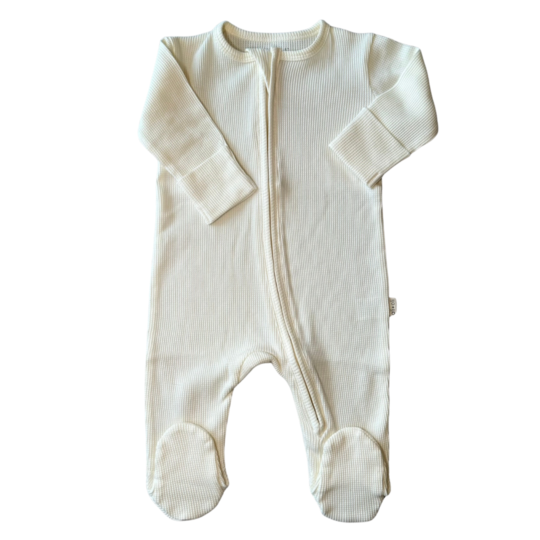A ivory organic cotton baby footie with a 2-way zipper and footie