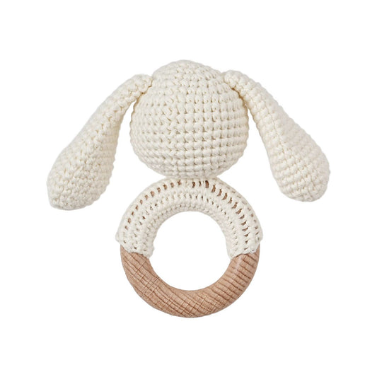 Knitted toy with bunny ears and ring on a white background