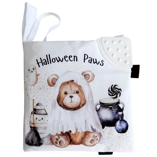 Soft book with a teddy bear in a Halloween costume and text 'Halloween Paws' on a white background.