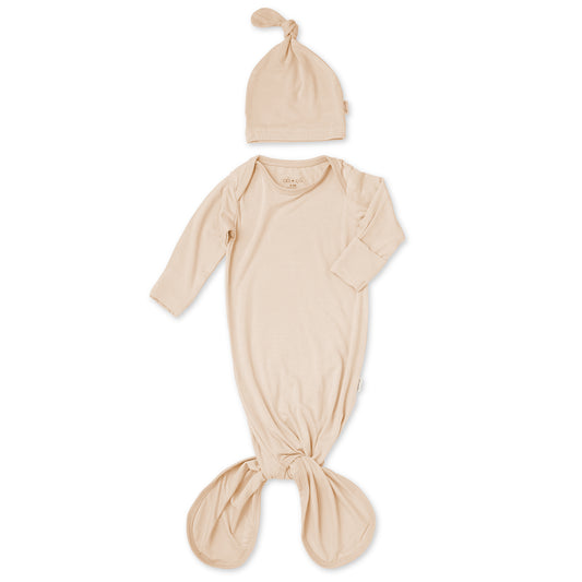Beige baby wrap and hat set on a white background