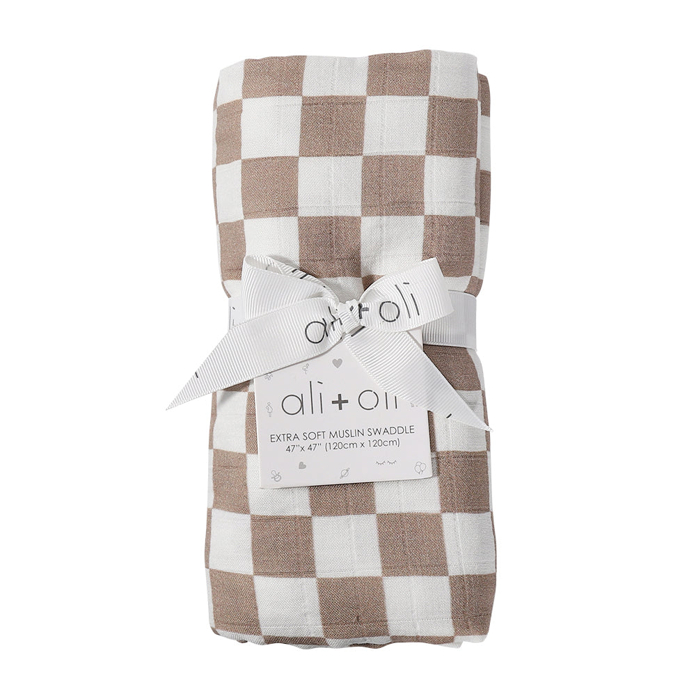 Checkered muslin swaddle with ali+oli label on a white background