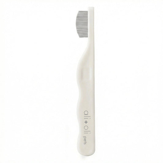 White pet toothbrush with a comb on a white background