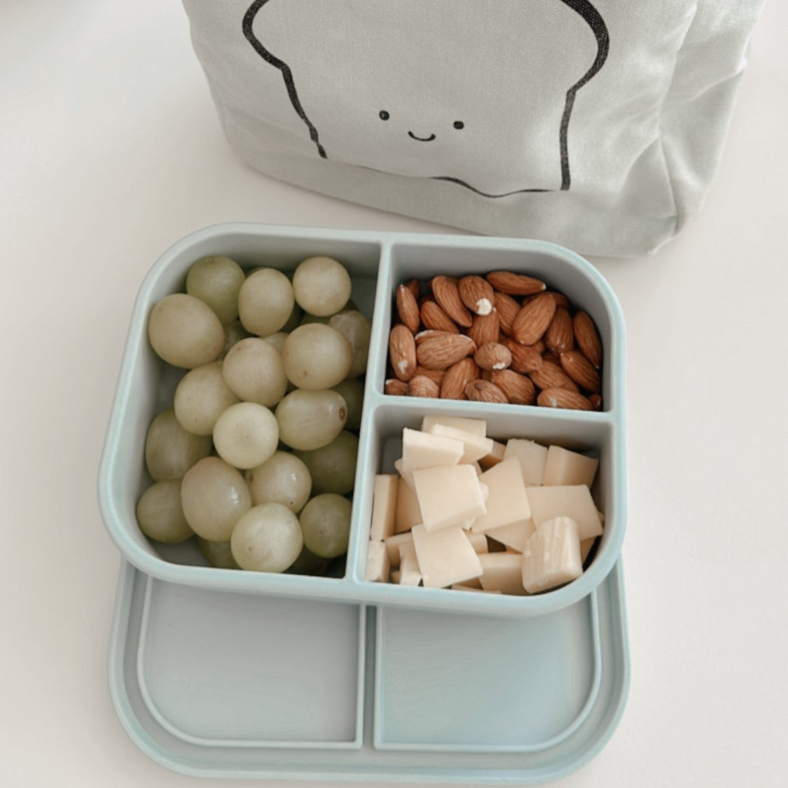 Bento box with grapes cheese and almonds for kids