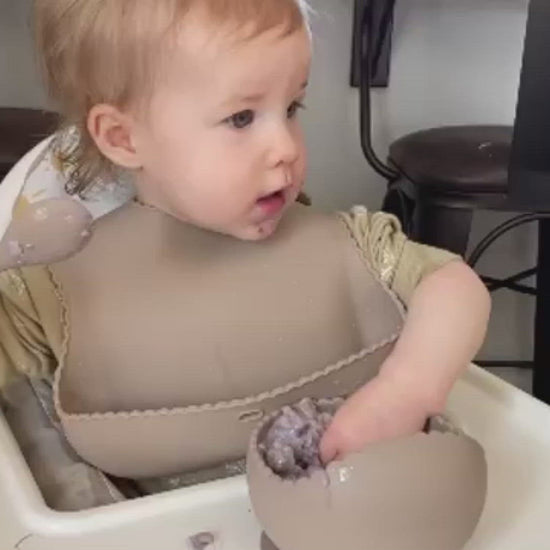 Baby eating silicone bowl and spoon
